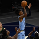 Ja Morant of Memphis shoots the ball against Juancho Hernangomez, Anthony Edwards, and Naz Reid of Minnesota during the third quarter of the game at Target Center on May 5, 2021, in Minneapolis, Minnesota.